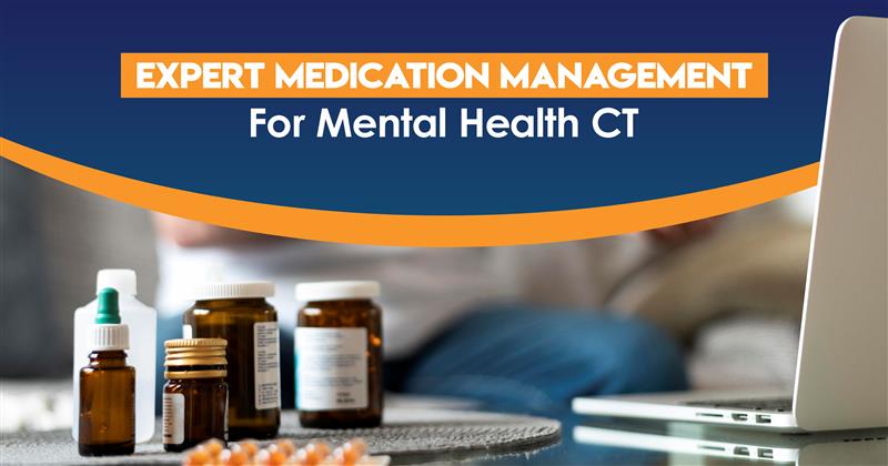 Medication bottles on a table beside a laptop, illustrating expert medication management for mental health in Connecticut.